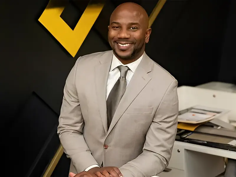 A man in a suit and tie sitting down.