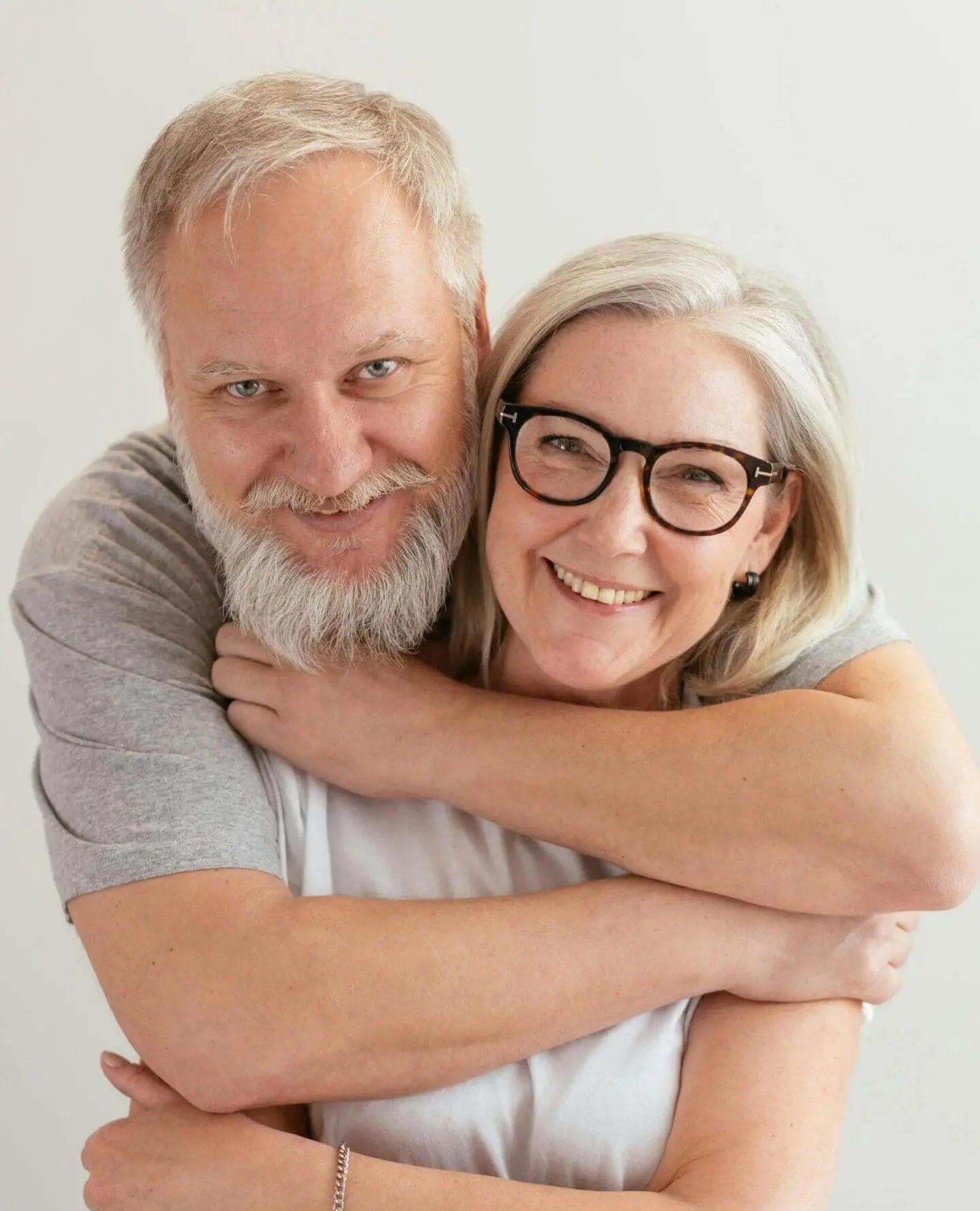 A man and woman hugging each other.